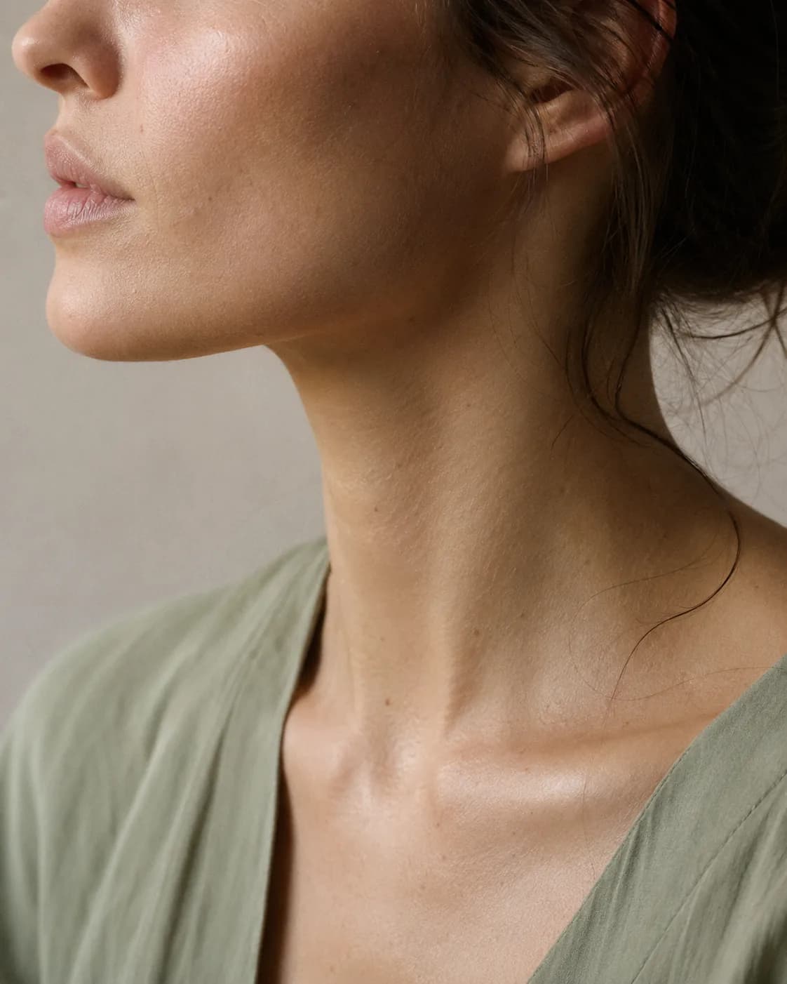 A woman with luminous glass skin, photographed in soft, even light.